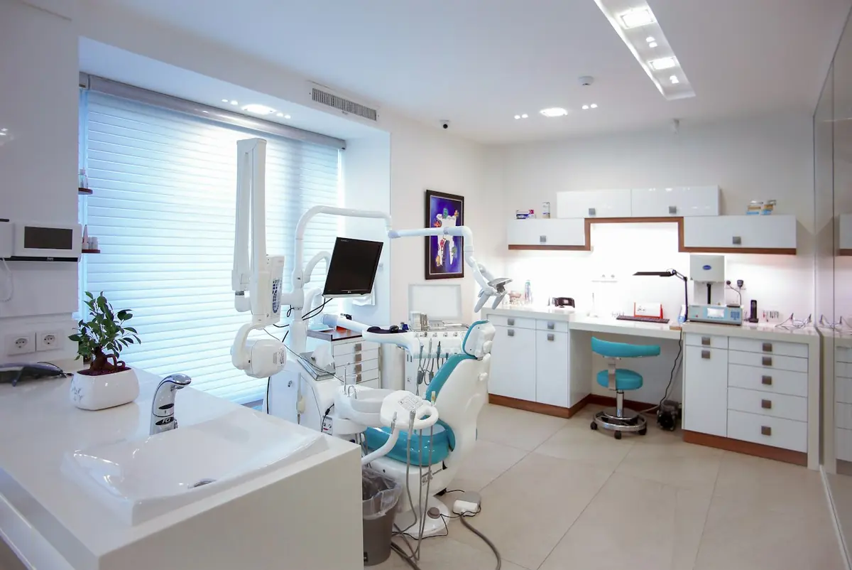 Bright, modern dental surgery with a treatment chair and equipment